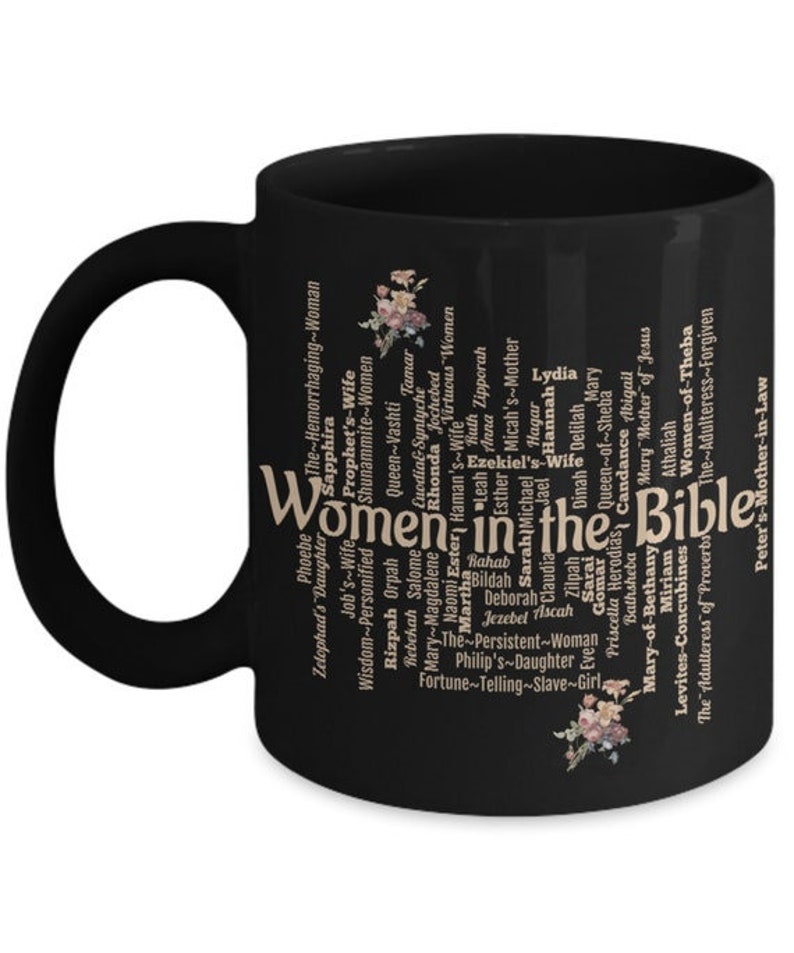 May include: Black ceramic mug with a white handle. The mug features a design of beige text that reads "Women in the Bible" with a list of women's names from the Bible. The text is surrounded by a floral design.