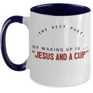 May include: White ceramic coffee mug with a blue rim and handle. The mug has a saying on it that reads "The best part of waking up is... "Jesus and a cup"
