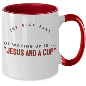 May include: White ceramic coffee mug with a red rim and handle. The mug has a quote that reads "The best part of waking up is... "Jesus and a cup""