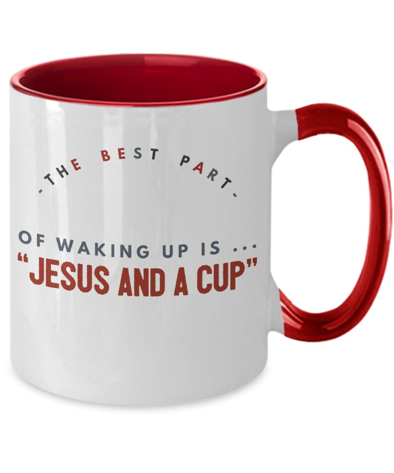 May include: White ceramic coffee mug with a red rim and handle. The mug has a quote that reads "The best part of waking up is... "Jesus and a cup""