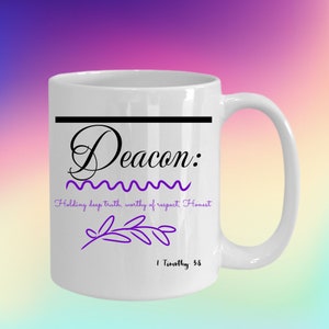 May include: White ceramic mug with a black line across the top and the word "Deacon" in black cursive lettering. The text "Holding deep truth, worthy of respect, Honest" is in black lettering below the word "Deacon". A purple branch design is below the text. The text "1 Timothy 3:8" is in black lettering below the branch design.