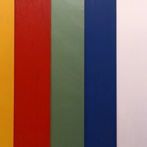 May include: A close-up of seven vertical strips of colored paper. The colors are yellow, red, green, blue, white, and black. The text "CHOP SHOP" is printed on the yellow strip.