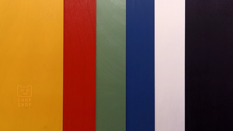 May include: A close-up of seven vertical strips of colored paper. The colors are yellow, red, green, blue, white, and black. The text "CHOP SHOP" is printed on the yellow strip.