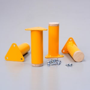 May include: Four yellow metal furniture legs with triangular bases and wood tops. The legs are arranged in a semi-circle with a pile of screws in the center.