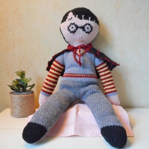 Hand-knitted doll of a little boy dressed as a wizard, made of wool