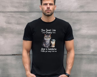 May include: Black t-shirt with a gray cat holding a cup of coffee. The text on the shirt reads "You Smell Like Drama And a Headache Please get away from me."