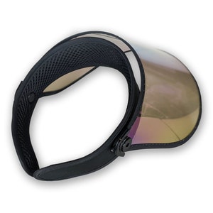 May include: A black visor with an iridescent, reflective shield. The visor features a mesh lining and an adjustable strap. The shield has a gradient of gold, purple, and green.