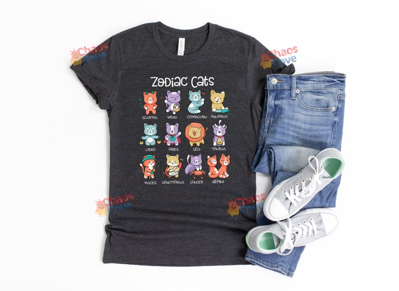 May include: A dark gray t-shirt with a graphic of zodiac signs represented by cats. The text "Zodiac Cats" is printed in white above the graphic.