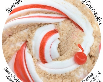 May include: A close-up of a swirl of red and white slime with a brown crumbly texture. The slime is scented with cherry cheesecake. The text "Slimentine" is visible in the upper left corner of the image. The text "Cloud & Butter Slime +Clear Slime" is visible in the lower left corner of the image. The text "Cherry Cheesecake" is visible in the upper right corner of the image. The text "Scented: Cheesecake & Cherry" is visible in the lower right corner of the image.