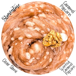 May include: Clear slime with a caramel popcorn scent. The slime is a light brown color with white spots and a swirl pattern. A piece of caramel popcorn and a white candy are on top. The text "Slimetine" and "Caramel Popcorn" are visible.