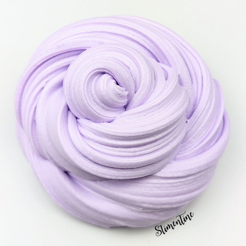 May include: A close-up of a light purple slime, a popular sensory toy, with a smooth, creamy texture. The slime is in a swirl pattern, creating a visually appealing and satisfying image.