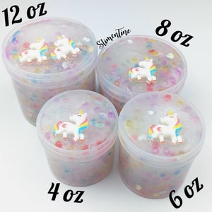 May include: Four clear containers of slime with unicorn charms. The containers are labeled 4 oz, 6 oz, 8 oz, and 12 oz.