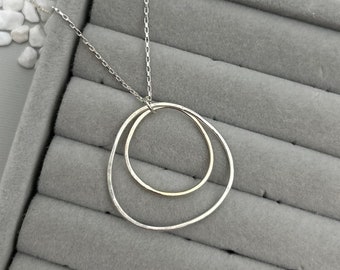 Organic circle necklace, layering necklace, silver circle pendant, hammered charm necklace, asymmetrical ring pendant, nested circles, ring
