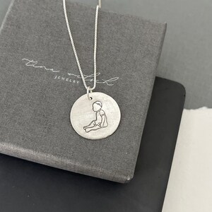 Baby necklace, sitting toddler charm, silver Stamped charm, gift for new mom, sterling silver baby pendant, baby with bow, handstamped