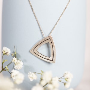 Layered silver triangle pendant necklace, double triangle charm with oxidized line, brushed silver finish, metal clay jewelry, gift idea