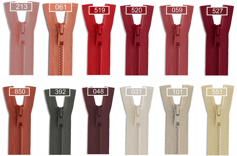 May include: A collection of twelve plastic zippers arranged in two rows, featuring a variety of colors including shades of pink, red, burgundy, grey, brown, and beige. Each zipper is labeled with a specific numerical code: 213, 061, 519, 520, 059, 527, 850, 392, 048, 031, 101, and 551.