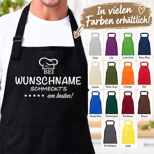 Pode incluir: Um avental preto com um ícone de chapéu de chef branco e o texto em alemão BEI WUNSCHNAME SCHMECKT'S am besten! com cinco estrelas. Um gráfico mostra dezasseis opções de cores diferentes para o avental, incluindo cinzento, roxo e amarelo.