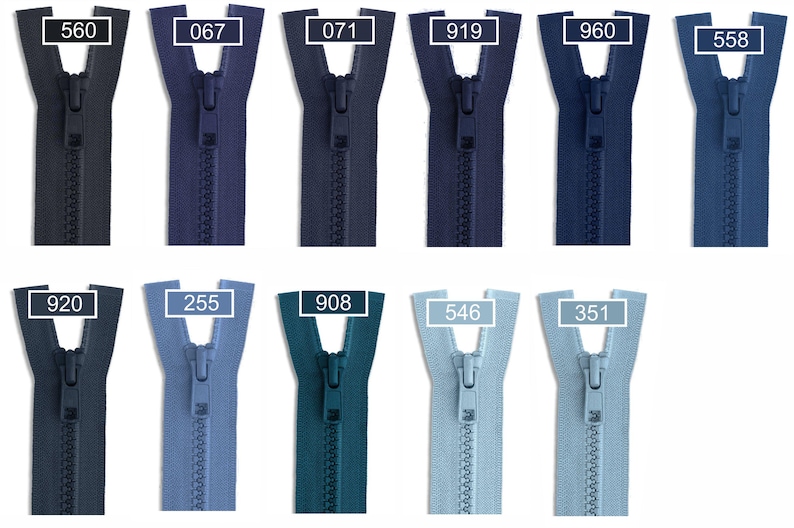 May include: Eleven plastic zippers arranged in two rows, displaying various shades of blue ranging from dark navy to light sky blue. Each zipper features a matching pull tab and a rectangular label with a white number: 560, 067, 071, 919, 960, 558, 920, 255, 908, 546, and 351.