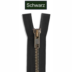 K&ouml;nnte beinhalten: Ein schwarzer Rei&szlig;verschluss mit metallisch bronzefarbenen Z&auml;hnen und einem passenden bronzefarbenen Schieber. Das obere Ende des Rei&szlig;verschlussbandes ist geteilt. &Uuml;ber dem Rei&szlig;verschluss befindet sich ein Etikett mit dem Wort Schwarz.