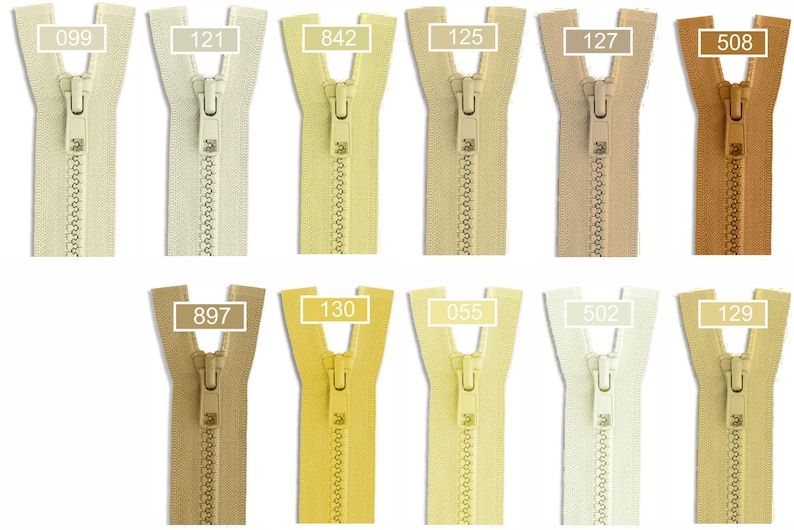May include: A collection of eleven nylon coil zippers arranged in two rows, featuring various shades of beige, cream, yellow, and tan. Each zipper includes a matching slider and a white rectangular label with a specific color code number.