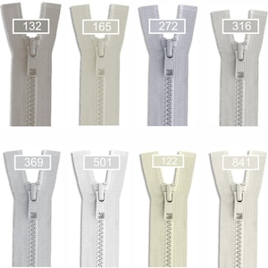 May include: A collection of twelve plastic zippers arranged in two rows, each featuring a unique neutral color shade. Every zipper includes a matching slider and a rectangular label displaying a specific identification number: 032, 132, 165, 272, 316, 337, 368, 369, 501, 122, 841, and 154.