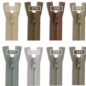 May include: A collection of twelve plastic zippers arranged in two rows, featuring various neutral and earth-toned colors. Each zipper includes a slider and a pull tab, with numerical labels 848, 085, 219, 568, 886, 325, 340, 577, 576, 225, 323, and 336.