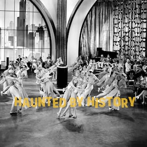 May include: A black and white film still showing a crowded ballroom with couples dancing on a polished floor. Large arched windows reveal a stylized city skyline. The text HAUNTED BY HISTORY is overlaid in yellow across the center foreground.