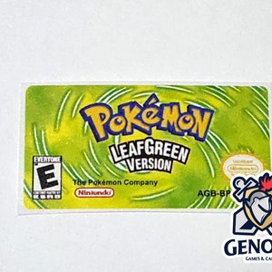 May include: A green and yellow game cartridge label for Pokemon LeafGreen Version for the Game Boy Advance. The label features the Pokemon logo, the game title, and the Nintendo logo.
