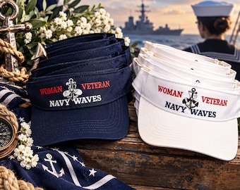 May include: A stack of navy blue and a stack of white sun visors, each featuring embroidered text that reads WOMAN VETERAN and NAVY WAVES, accompanied by a central anchor graphic. The visors are made of fabric and have a curved brim.
