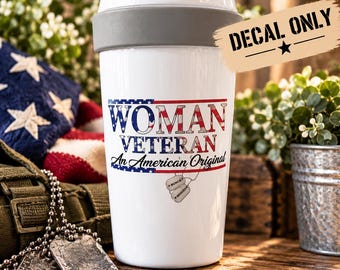 May include: A white tumbler with a gray rim and a clear lid featuring a graphic of the American flag and the text "WOMAN VETERAN An American Original" in blue and red. Below the text are two silver-toned dog tags with the words "HONOR" and "BRAVERY".
