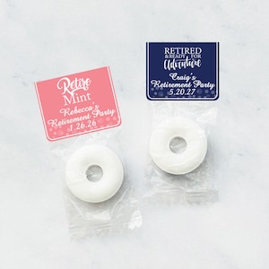May include: Two small bags of white mints with personalized labels. The pink label says "Retire Mint" and "Rebecca's Retirement Party 1.26.26". The blue label says "Retired & Ready for Adventure" and "Craig's Retirement Party 5.20.27".
