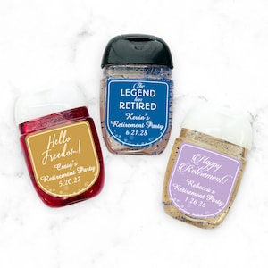 May include: Three small clear plastic bottles with colorful labels. The labels have text that says "Hello Freedom! Craig's Retirement Party 5.20.27", "The Legend has Retired Kevin's Retirement Party 6.21.28", and "Happy Retirement! Rebecca's Retirement Party 1.26.26".