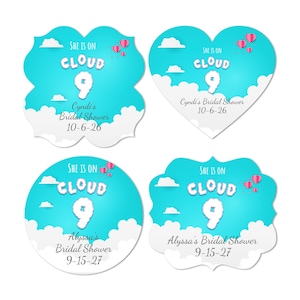 May include: Four different designs of bridal shower invitations. Each design features a blue sky with white clouds and pink hot air balloons. The text "She is on Cloud 9" is featured on each design. Each design also includes the name of the bride and the date of the bridal shower.