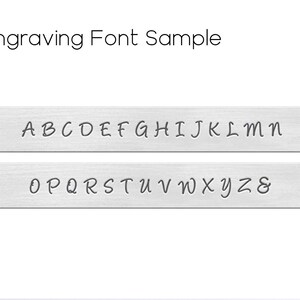 May include: Engraving font sample showing the alphabet in uppercase letters A through Z and the ampersand symbol. The font is a cursive script style.