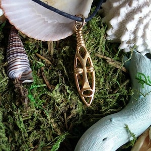 Tribal gold face pendant on hemp