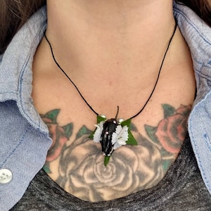 Black Fruit Bat skull adorned with Swarsovski crystals and faux flowers