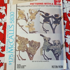 May include: A sewing pattern for making stuffed animals. The pattern includes instructions for easy velcro fasteners. The pattern is for a set of stuffed animals, including a monkey, a koala, and a raccoon.