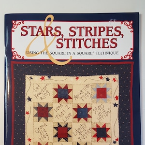 May include: A book cover titled "Stars, Stripes, Stitches" with a patriotic theme. The cover features a quilt design with star patterns and handwritten phrases like "Land That I Love" and "American Flag". The book is by Kasi Skelly & Jodi Barrows.