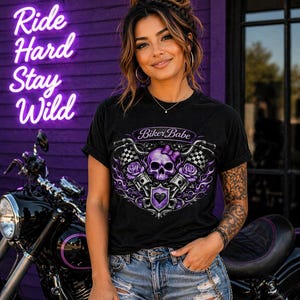 May include: Black t-shirt with a purple skull graphic, the words "Biker Babe", and motorcycle parts. The background features a motorcycle and a purple wall with the neon sign "Ride Hard Stay Wild".