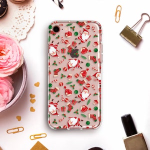 May include: A clear phone case with a festive Christmas design. The case features a repeating pattern of Santa Claus, candy canes, ornaments, and holly.