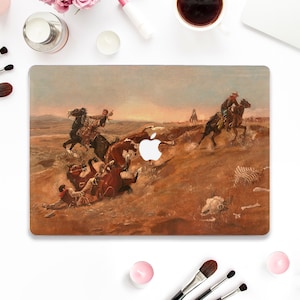 May include: A vintage painting of a cowboy on horseback rounding up cattle in a dusty landscape. The painting is printed on a laptop skin, which is a protective cover for a laptop.