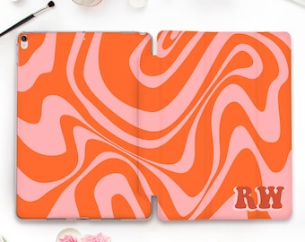 May include: Orange and pink swirl pattern iPad case with the initials "RW" in a retro font.