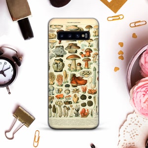 May include: A clear phone case with a vintage illustration of various mushrooms. The illustration is in shades of brown, red, white, and green. The text "CHAMPIGNONS" is at the top of the illustration.