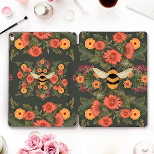 May include: A green iPad case featuring a floral design and a bee in the centre. The flowers are orange, yellow and red.