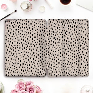 May include: A beige iPad case with a black and white polka dot pattern.