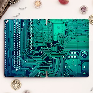 May include: A teal and black iPad case with a circuit board design.