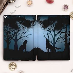 May include: A black and blue iPad case with a wolf howling at the moon in a forest scene. The wolf's eyes are visible in the background.