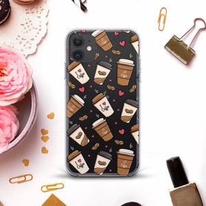 May include: A clear phone case with a black background and a repeating pattern of coffee cups and hearts. The coffee cups are brown and white with the text "I love Coffee" on some of them. The hearts are red.