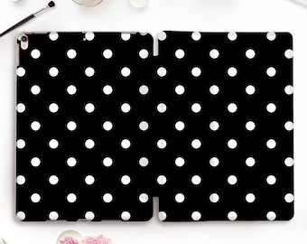 May include: A black iPad case with a white polka dot pattern.