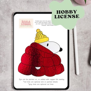 May include: A digital tablet displays a Snoopy illustration wearing a red coat and yellow hat. The image is labeled "HOBBY LICENSE" and includes text about resizing the pattern and crediting "Akala Studios."